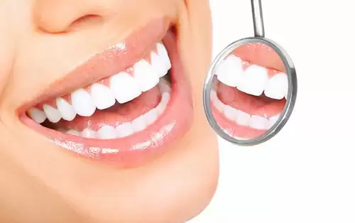 Bright smile reflected in a dental mirror